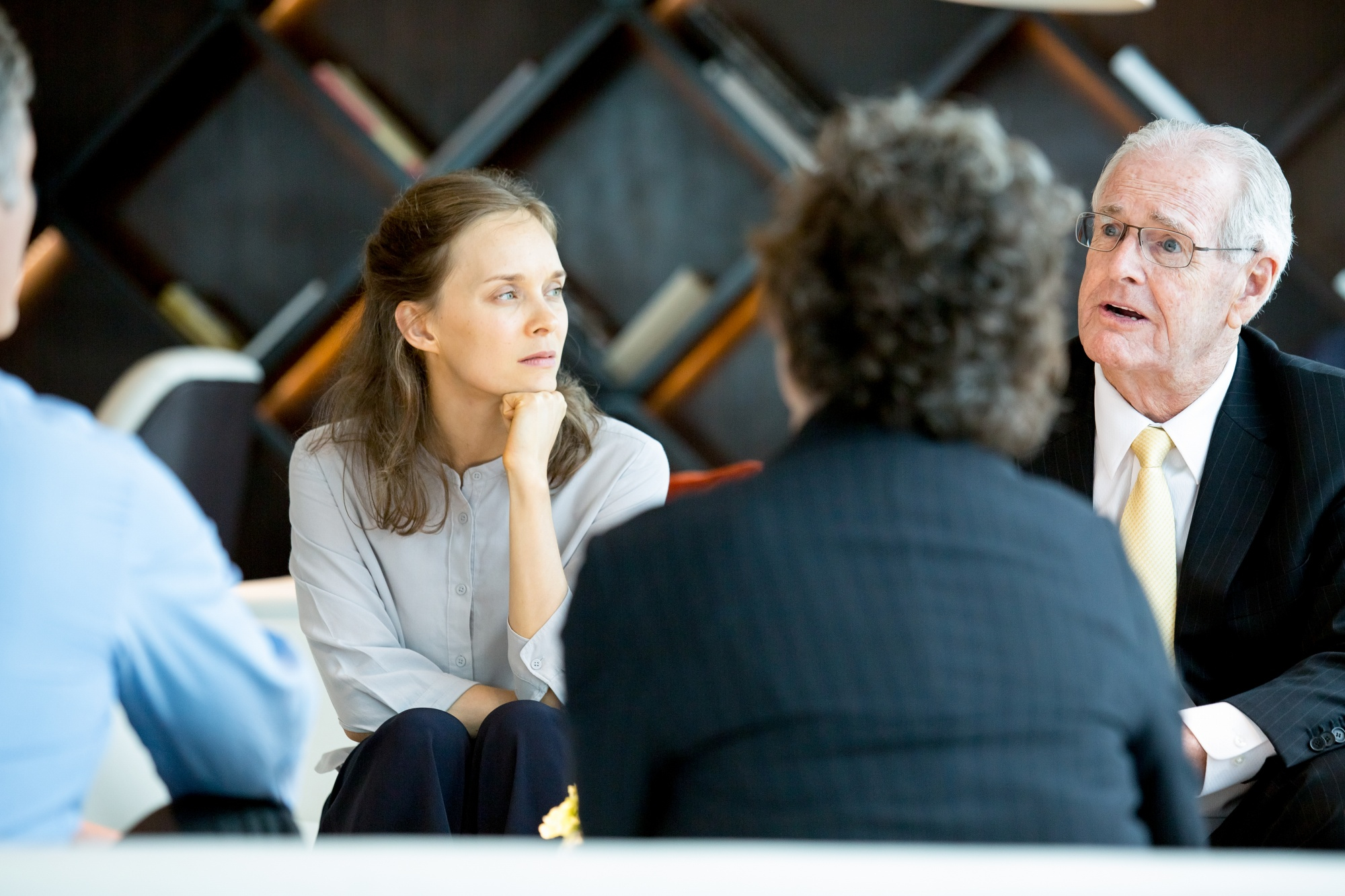 Business professionals listening during a group meeting